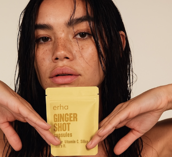 Woman holding erha Ginger Shot Capsules